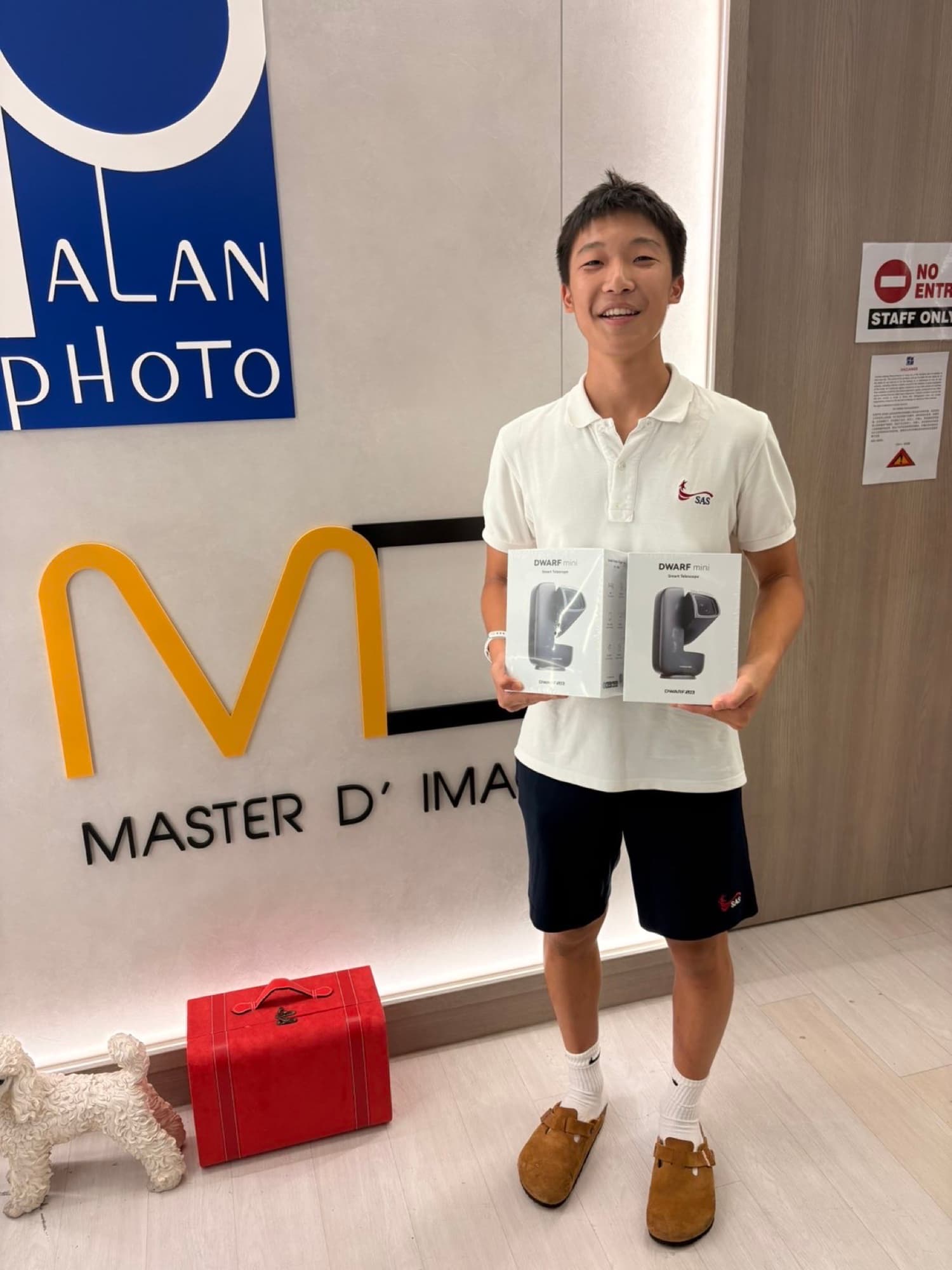 Sam holding two DWARF mini smart telescopes from AstroYouth's equipment partners