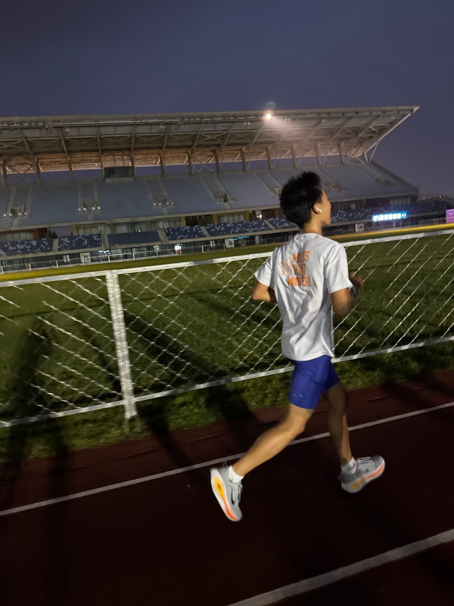 Sam running on the track at night
