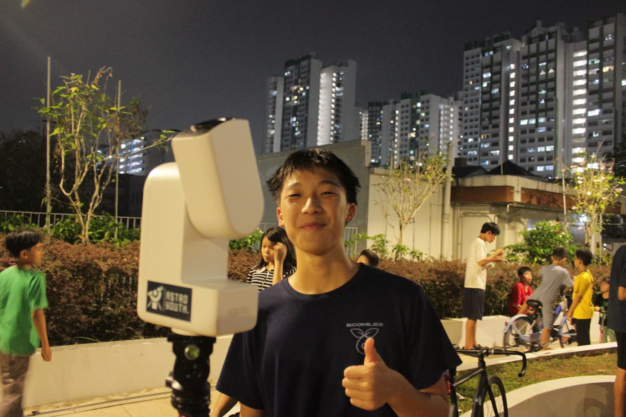 Sam with a telescope at night